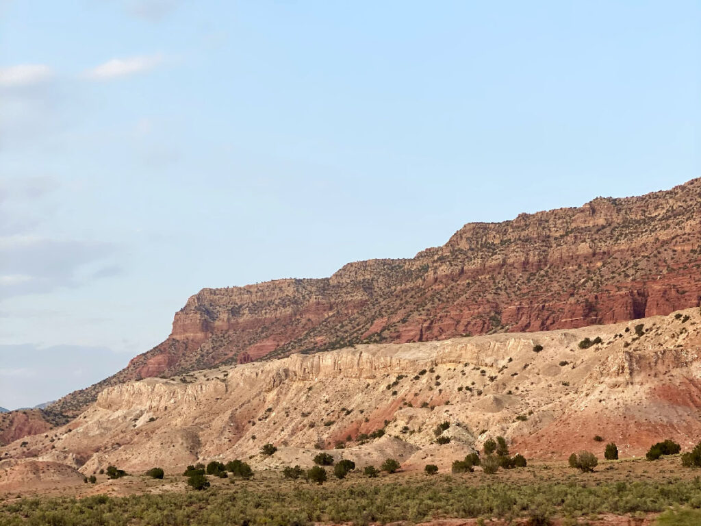 Flat-topped mountain in New Mexico with exposed rock layers and dry desert landscape